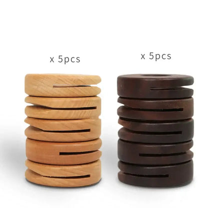 Two stacks of decorbites black walnut donuts bag clips in natural light and dark brown wood for kitchen sealing
