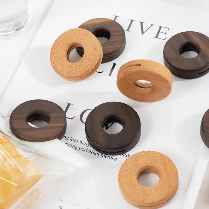Wooden ring-shaped bag clips in natural and dark brown finishes made of smooth decorbites black walnut donuts wood