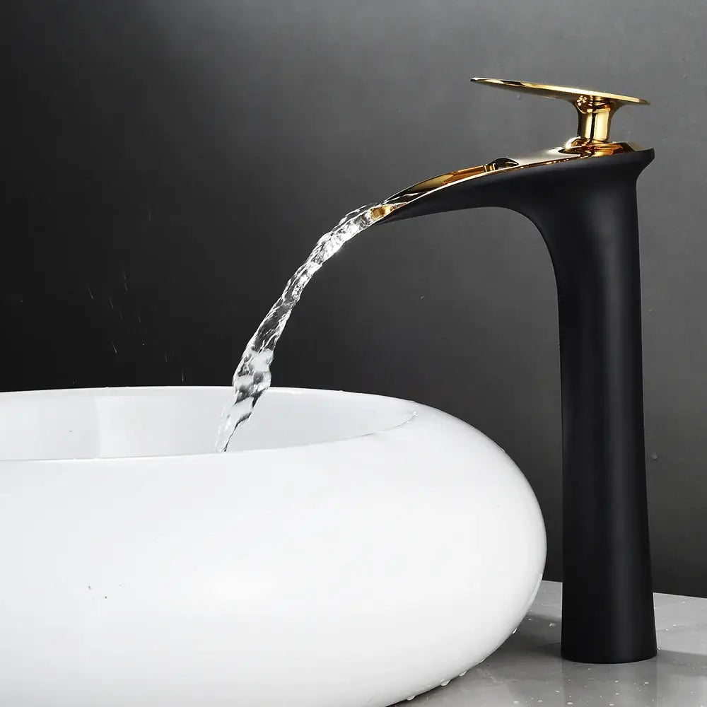 Decorbites™ black waterfall bathroom faucet mixer tap with gold-toned spout flowing water into white ceramic sink basin faucets modern
