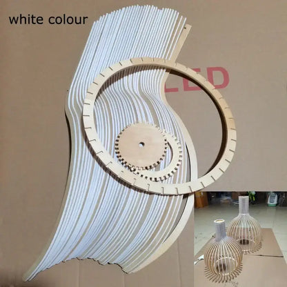 White wooden wall art with layered curved slats and central gear design complementing decorbites black wood cage chandelier