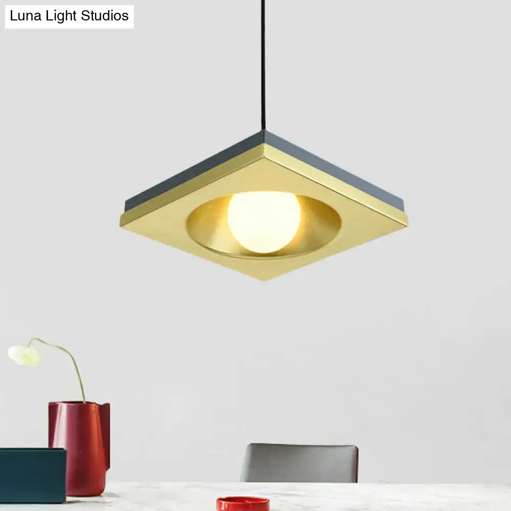 DecorBites™ pendant light with brushed gold finish, dark gray metal squares, and illuminated bulb base for bedrooms