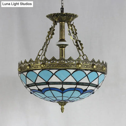 Antique brass-finished decorbites pendant light with baroque bowl stained glass shade in blue and white scalloped design