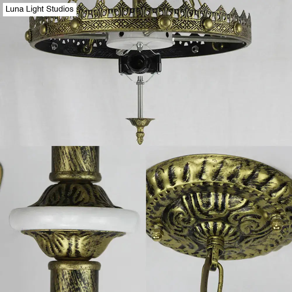 Antique brass ornate ceiling chandelier featuring intricate filigree and white ceramic accent ring for baroque bowl pendant light
