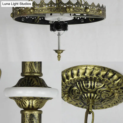 Antique brass ornate ceiling chandelier featuring intricate filigree and white ceramic accent ring for baroque bowl pendant light