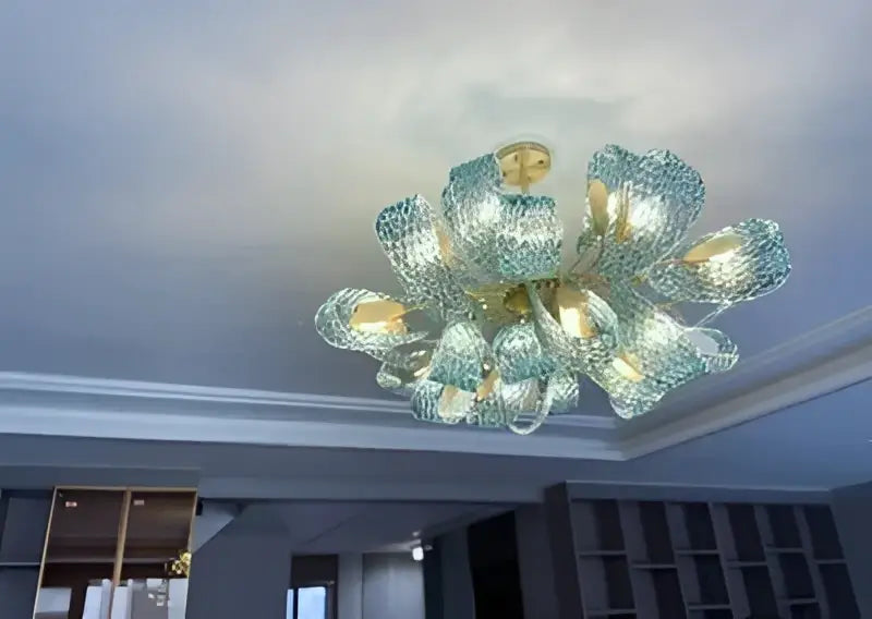 DecorBites™ blue glass led pendant lamps feature a modern teal glass chandelier with gold-toned floral design
