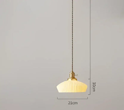 A warm cream-colored pendant light with ribbed glass shade and brass fixture for dining room decorbites blue glass pendant