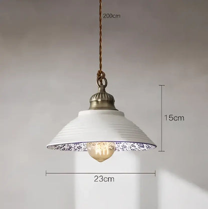 White ceramic pendant light with blue floral rim and antique brass fixture for dining room featuring decorbites blue glass pendant lights