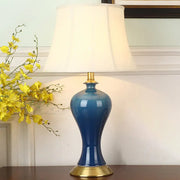 Deep blue ceramic bedside table lamp with gold metal base and modern empire shade night light by decorbites