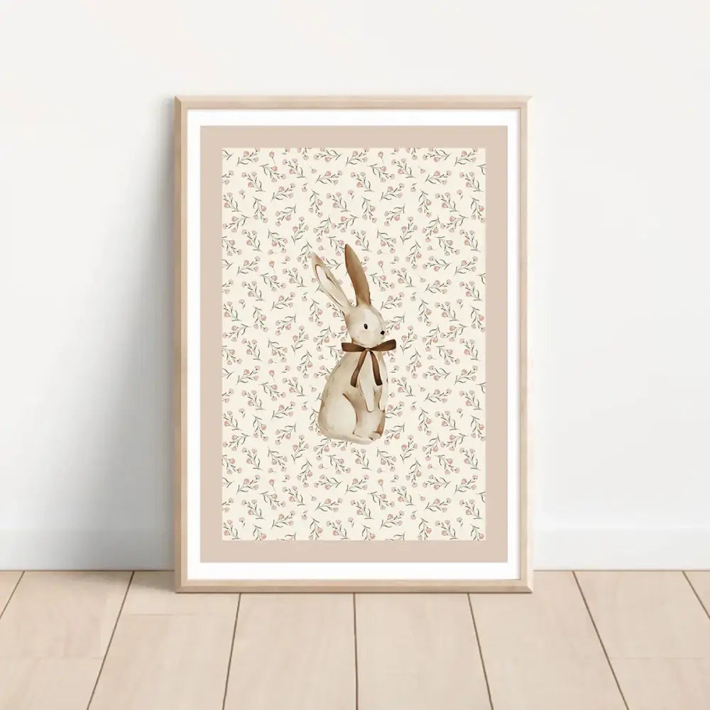 A framed beige rabbit illustration with a brown bow on floral background in decorbites bohemian style wall art set