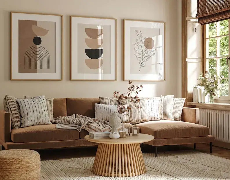 Brown velvet sectional sofa with striped and solid throw pillows beside decorbites bohemian geometric plant wall art set