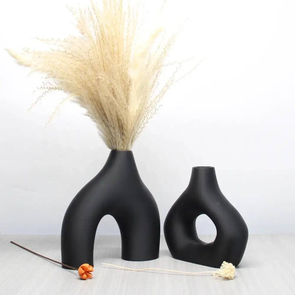 Black ceramic vase set with abstract organic shapes and matte finishes for bohemian home decor by decorbites