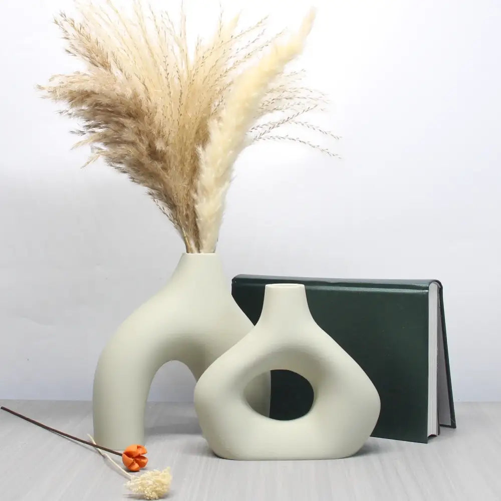 Cream-colored ceramic vase set with organic shapes and matte finish for bohemian home decor by decorbites