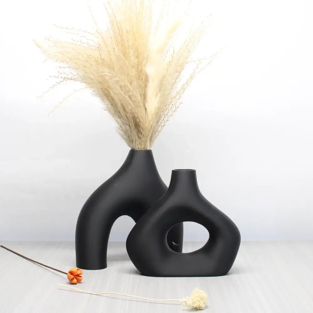 Decorbites™ bohemian home decor vase set featuring two matte black ceramic vases with abstract cut-out designs