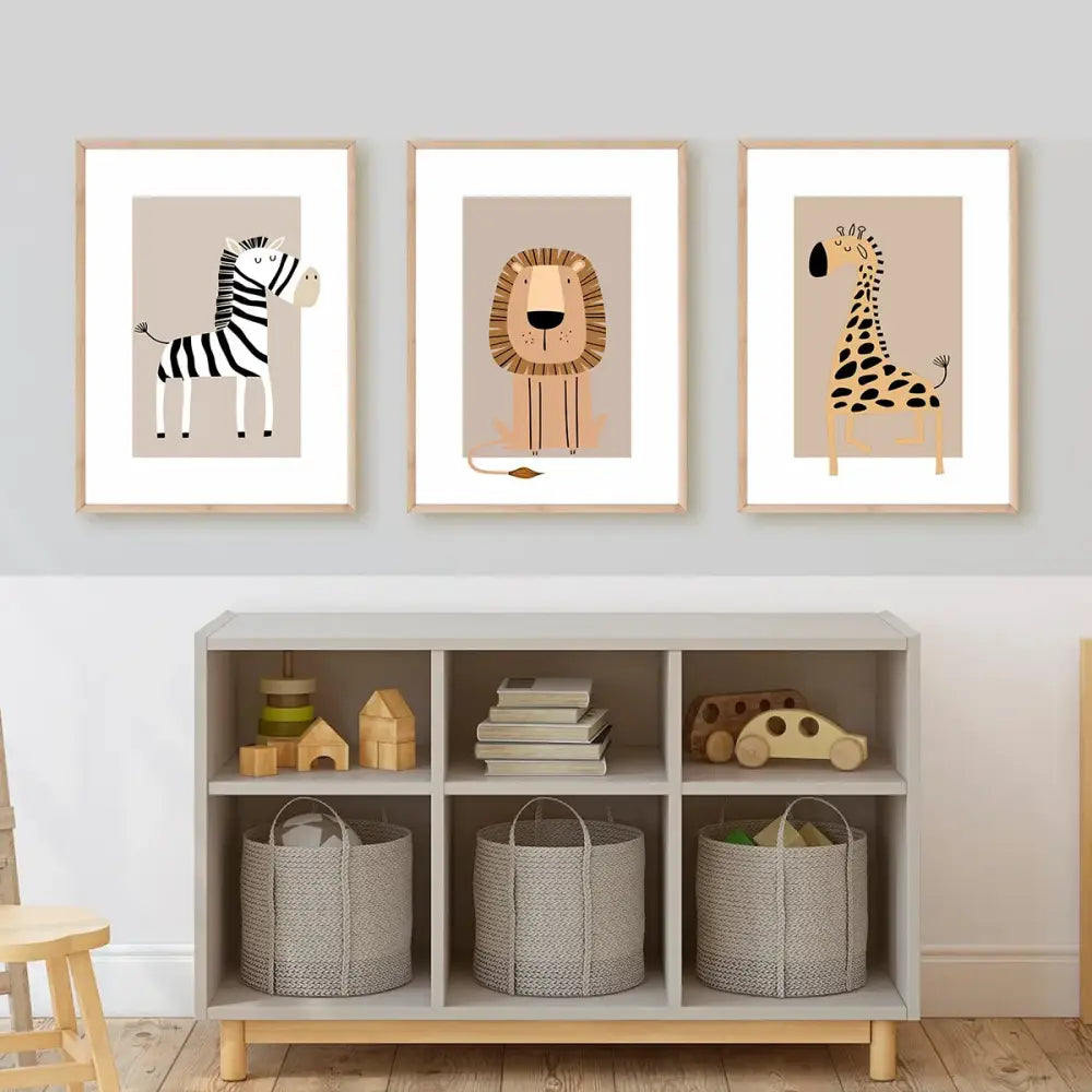 Three framed bohemian jungle animal toddler canvas prints featuring zebra lion and giraffe in natural wood frames for forest art room