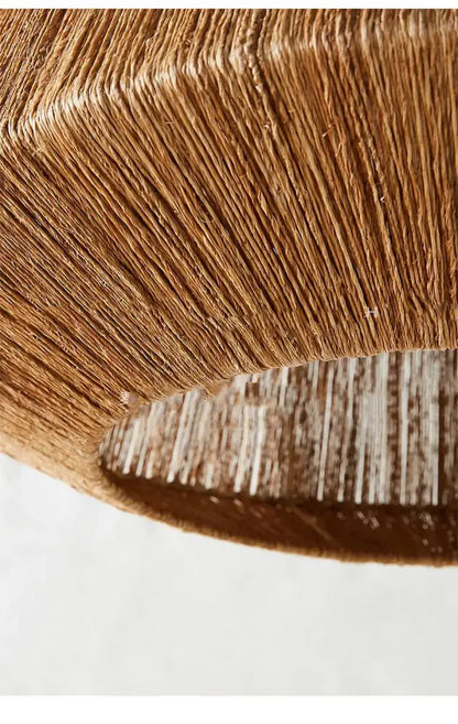 A woven light brown paper lampshade with ribbed texture in the decorbites bohemian rattan chandelier tiered bamboo light