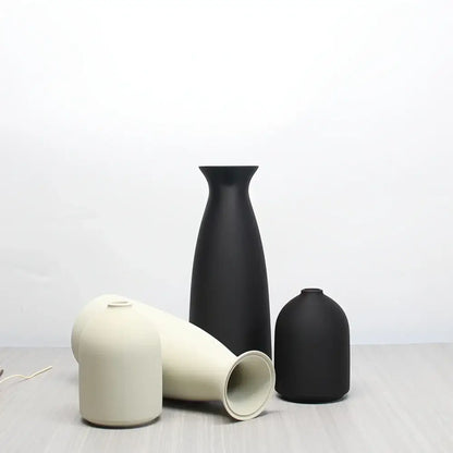 Minimalist matte black and off-white ceramic bohemian style decorative vase set with sleek modern silhouettes by DecorBites