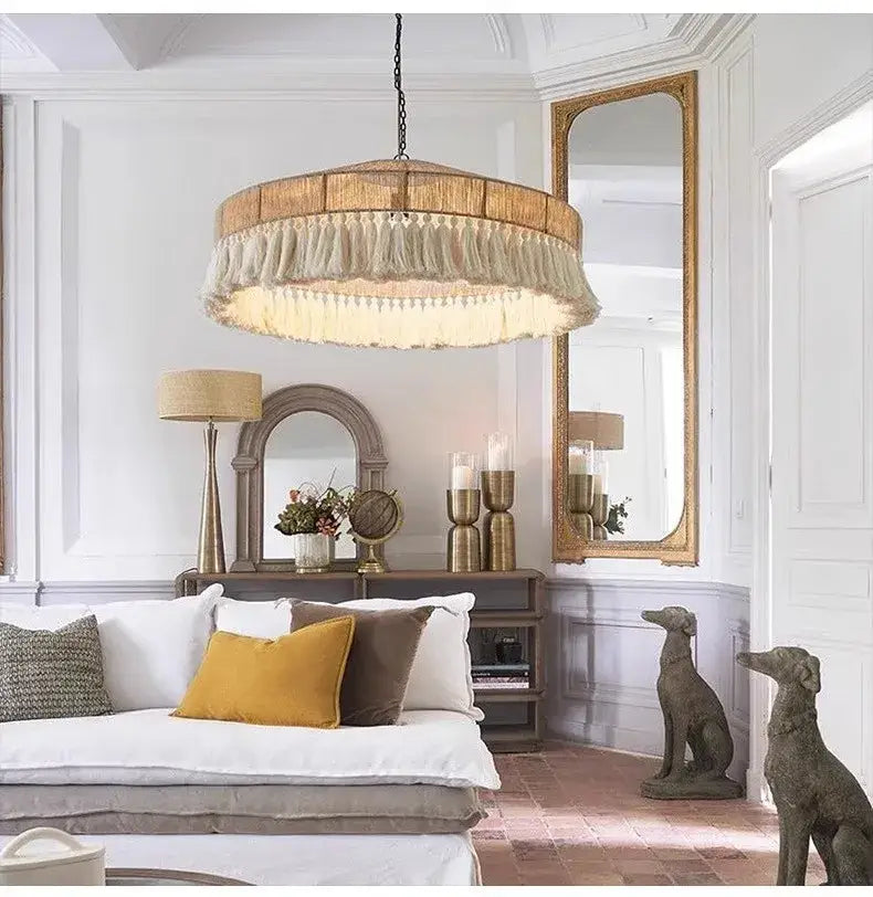 A decorbites bohemian tassel chandelier with a rustic wooden circular frame and natural woven tassels for bedroom light