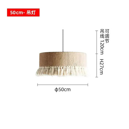 A beige cylindrical decorbites bohemian tassel chandelier with textured fabric and white tassels for bedroom lighting