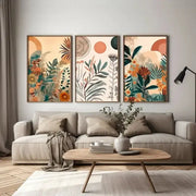 Set of three framed boho floral modern canvas art prints with vibrant orange green and earth-toned abstract motifs