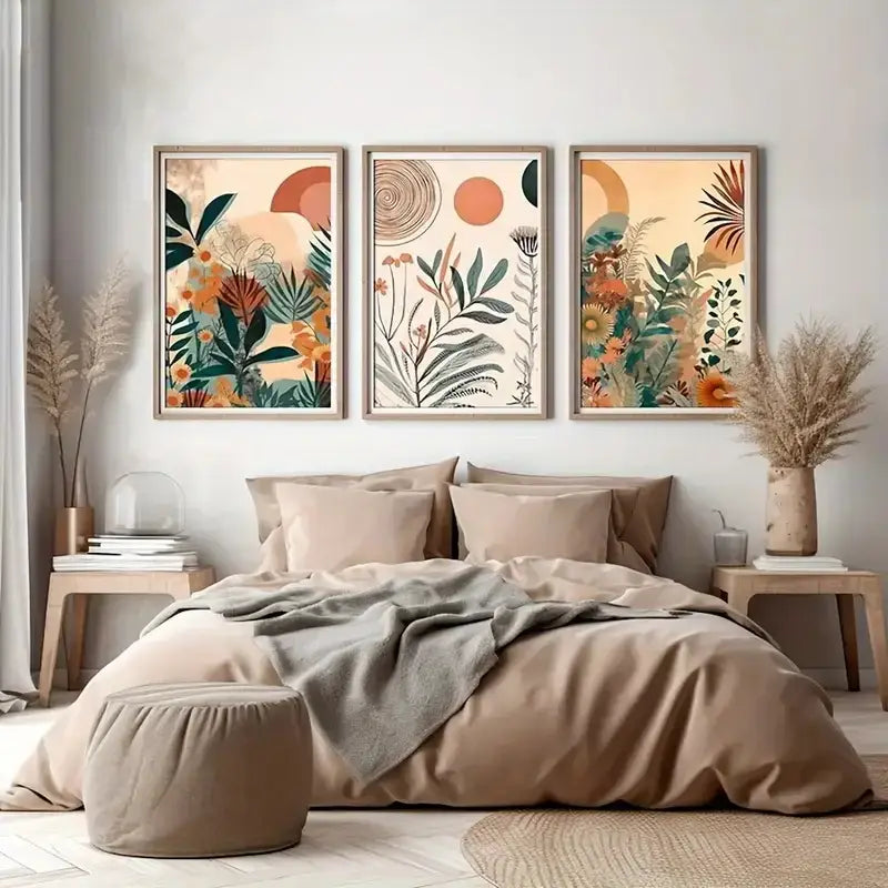 Three framed decorbites™ boho floral modern canvas art prints with earthy tones and stylized plant motifs above a bed