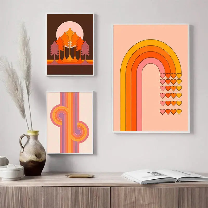 Three framed vintage-style boho sunset rainbow art prints with retro colors and geometric designs above wooden cabinet