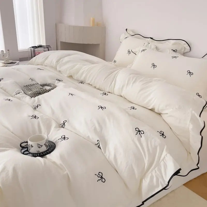 White duvet set with black bow embroidery and matching pillowcases from decorbites™ bow embroidery bedding set with ruffles