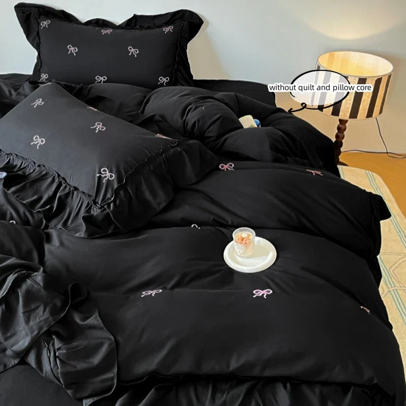 DecorBites™ black satin bow embroidery bedding set with delicate white and pink embroidered bows and ruffles