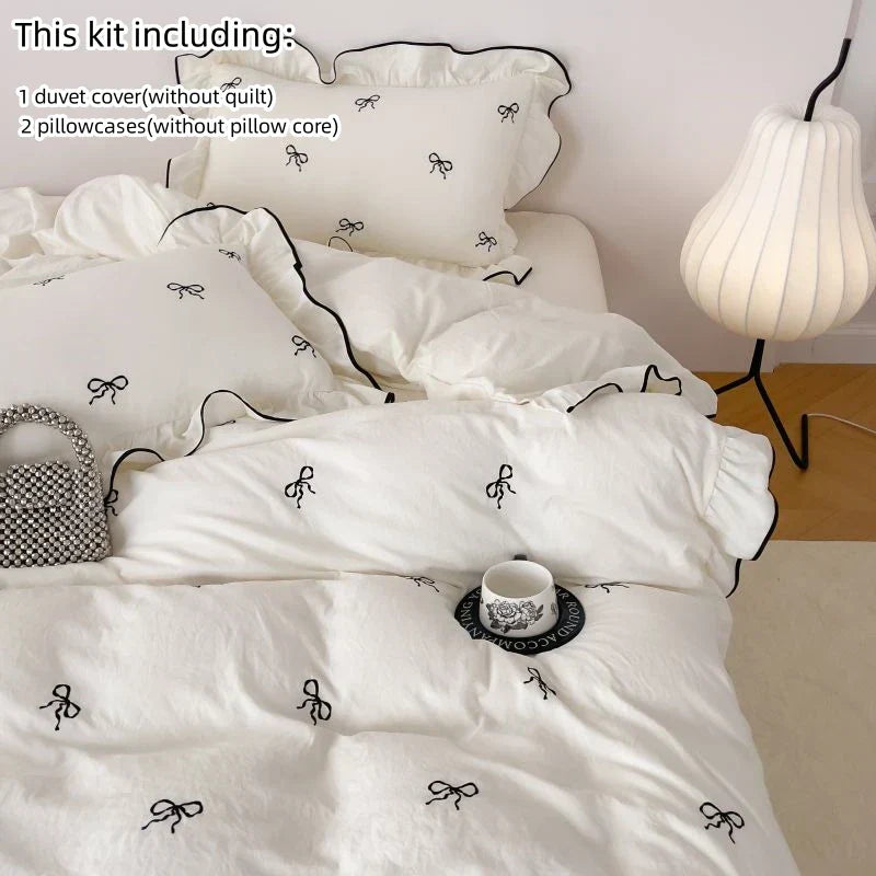 White duvet cover with black bow embroidery and ruffled edges from decorbites bow embroidery bedding set