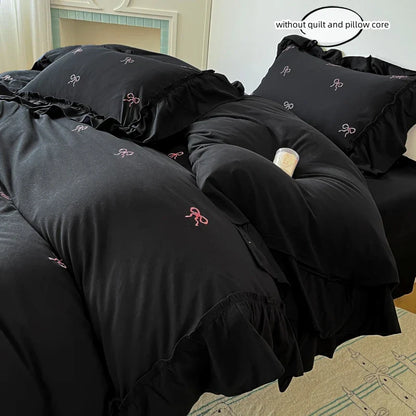 Black ruffled decorbites™ bow embroidery bedding set with delicate pink ribbon embroidery for elegant bedroom decor