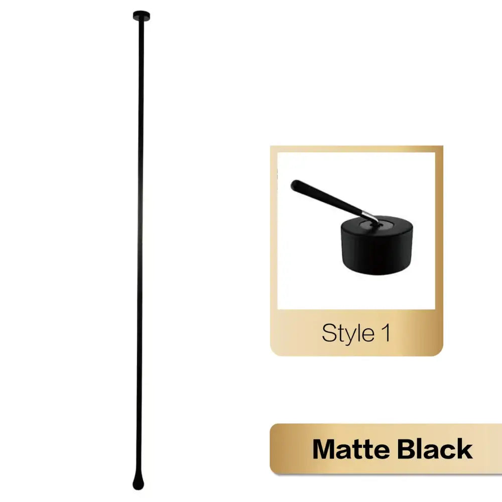 Matte black cocktail stirrer with sleek slender design and rounded ends accompanying brass black luxury single handle faucet