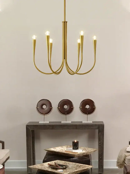 Gold-toned decorbites brass chandelier with six curved arms and frosted bulb fixtures for dining room use