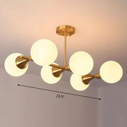 Decorbites brass finish linear island pendant with six white clear glass ball shades in modern postmodern style