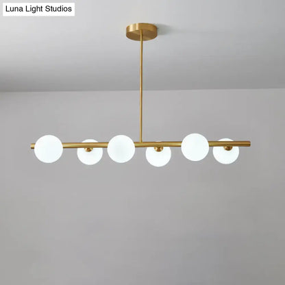 DecorBites brass island pendant light with six frosted glass globes in linear design for dining room ceiling light