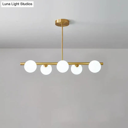 DecorBites brass island pendant light fixture with five frosted glass globes for dining room ceiling light