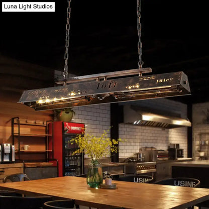 DecorBites brass island pendant light with industrial metal frame, etched lettering, chain suspension, and warm led lighting
