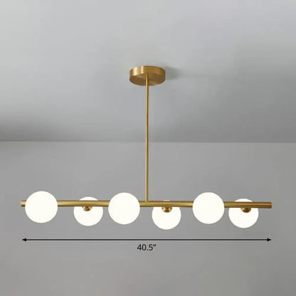 DecorBites brass plated glass sphere island pendant light with five gold-toned clear white frosted glass globes