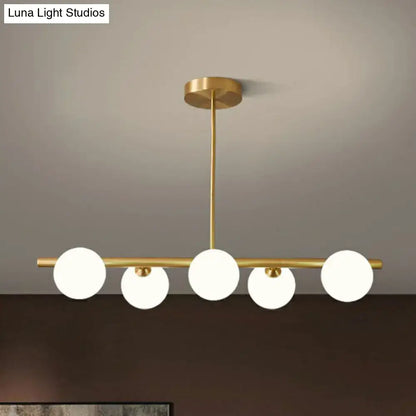 Decorbites brass plated glass sphere island pendant light with five frosted glass globe bulbs in clear white finish