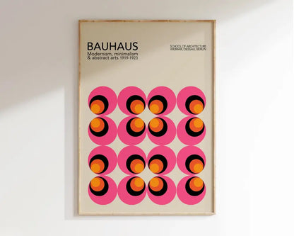 A framed DecorBites™ bright geometric canvas print with pink circles and orange black rings for home decor