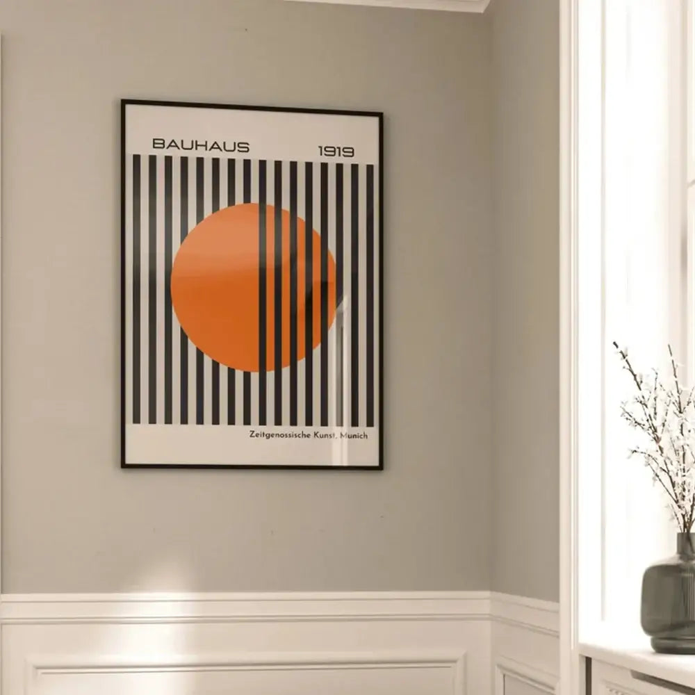 A framed canvas painting featuring bright orange circle and bold black stripes for modern home decor by decorbites