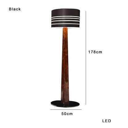 Black led floor lamp with tall brown leather wooden marble base and cylindrical shade with white stripes by Decorbites