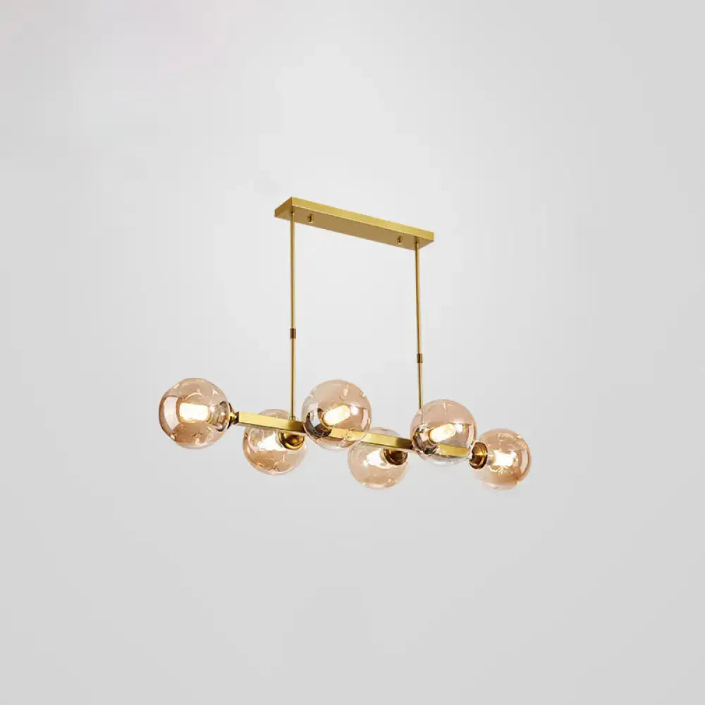 Gold-toned DecorBites™ Bubbles pendant light features five frosted glass globe bulbs in a linear modern design