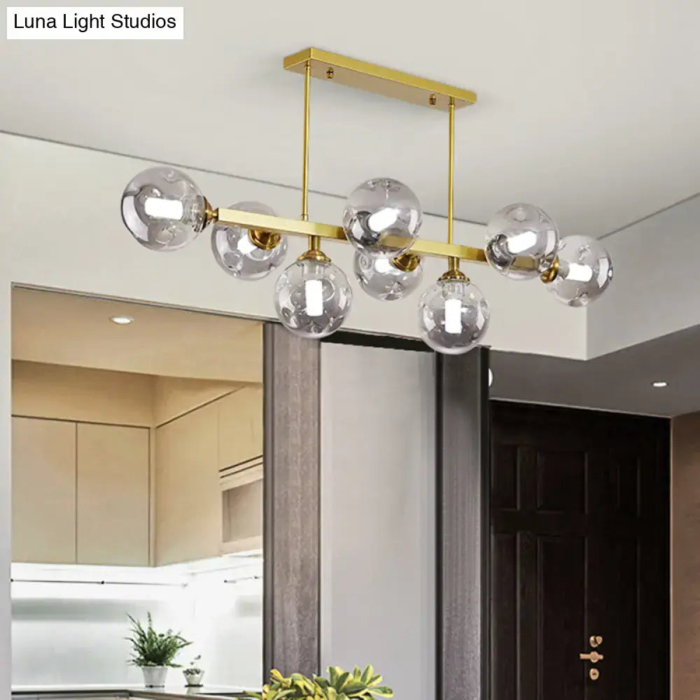 Gold-toned DecorBites™ Bubbles glass pendant light features clear glass globe bulbs for stylish island and dining use