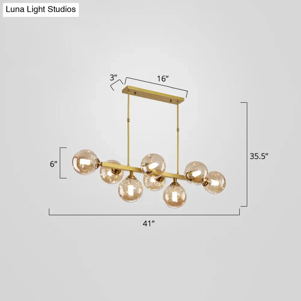 DecorBites™ bubbles glass pendant light with gold-toned frame and seven spherical bulbs features stylish postmodern design