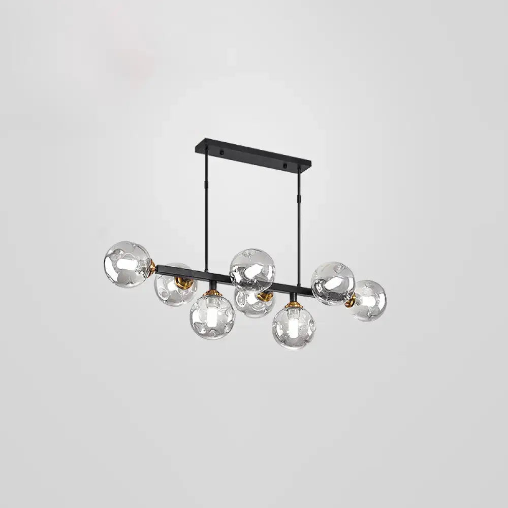 Modern black metal pendant light with clear glass globe bulbs and gold-toned accents featuring stylish light features