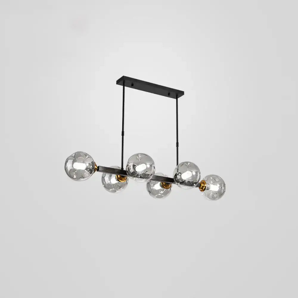DecorBites™ bubbles glass pendant light features modern black metal and brass accents with five clear glass globe bulbs