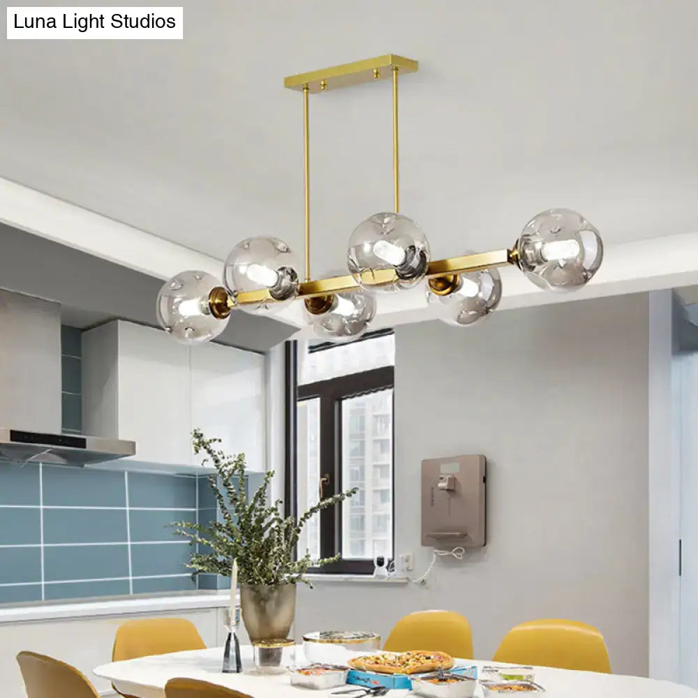 DecorBites™ pendant light features a modern gold-toned metallic frame with five clear glass globe bulbs for stylish lighting