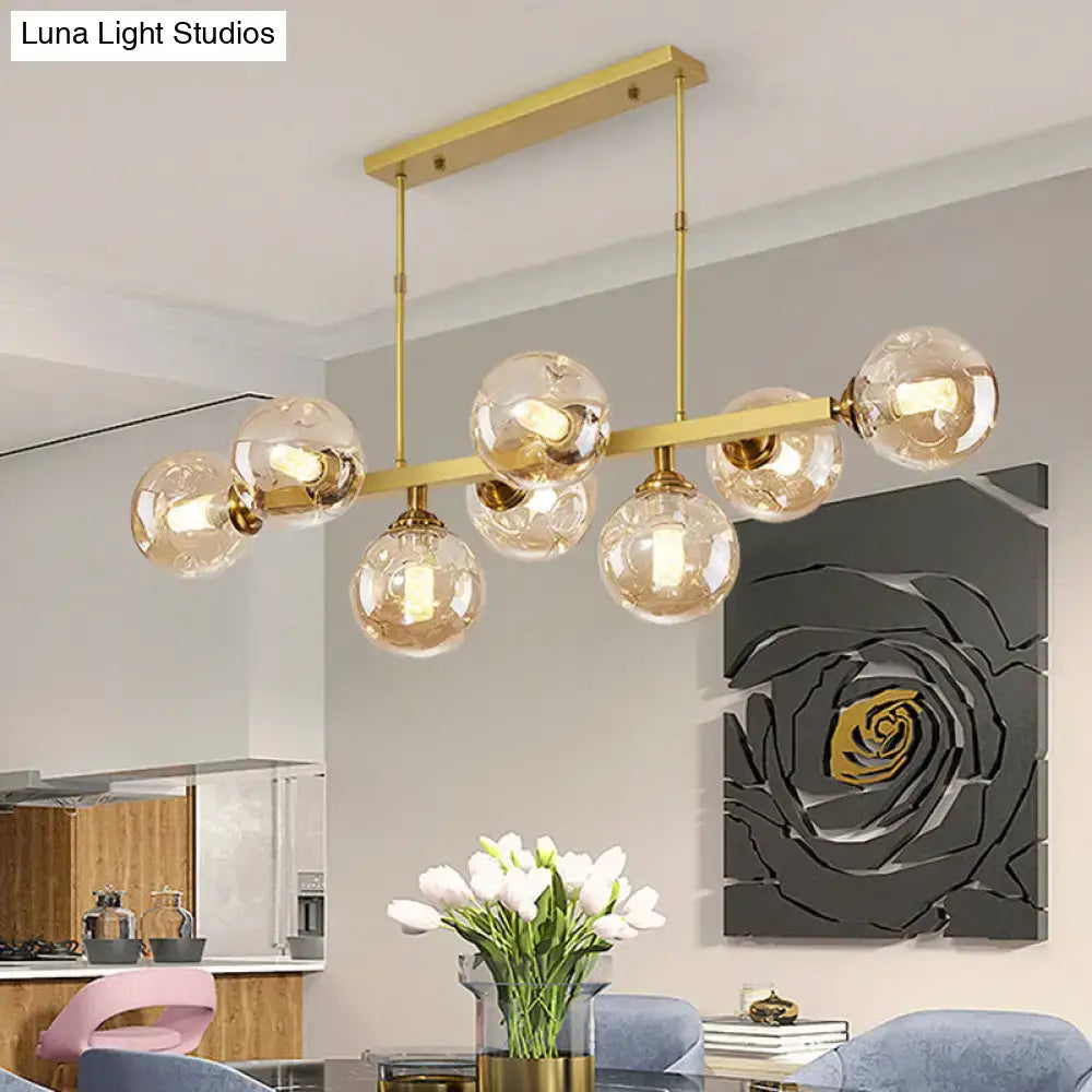 DecorBites™ bubbles glass pendant light features gold-toned spherical bulbs on a sleek bar for stylish island lighting