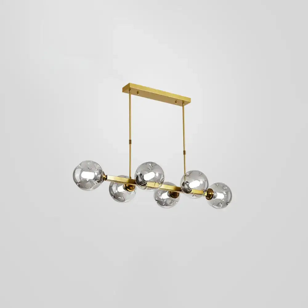 DecorBites™ bubbles pendant light with five clear glass globes and gold-toned features for postmodern dining