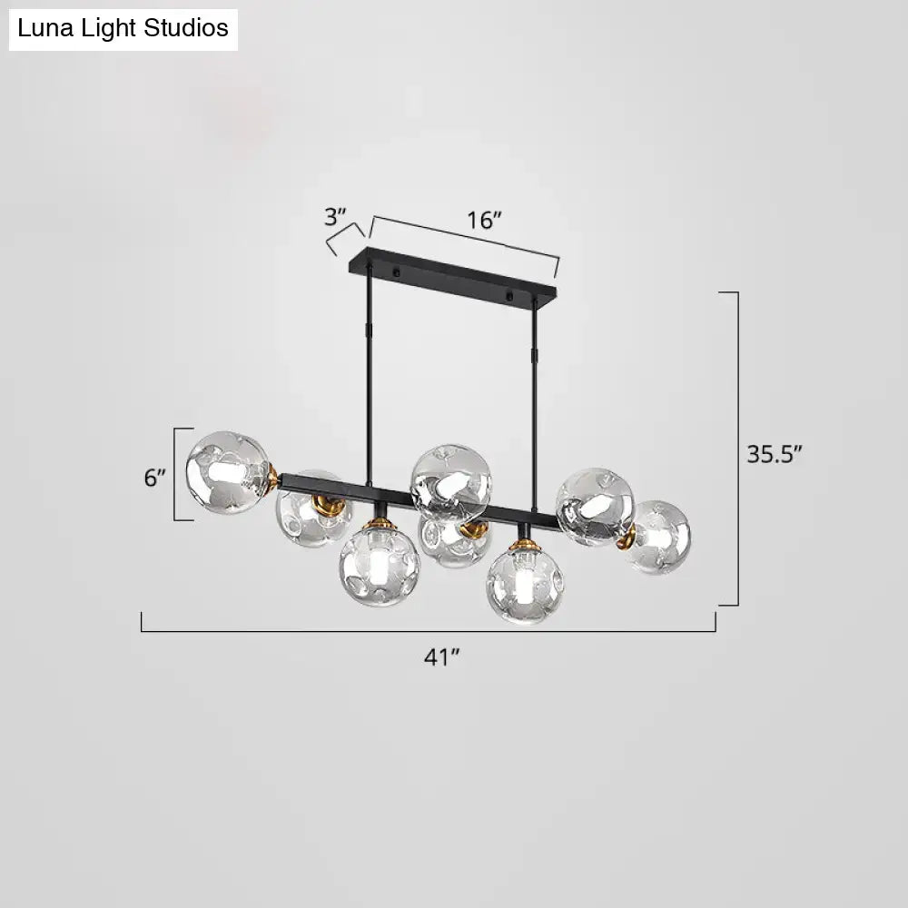 DecorBites™ bubbles glass pendant light with black metal frame seven clear globe bulbs gold-toned accents pendant light features
