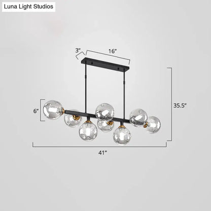 DecorBites™ bubbles glass pendant light with black metal frame seven clear globe bulbs gold-toned accents pendant light features